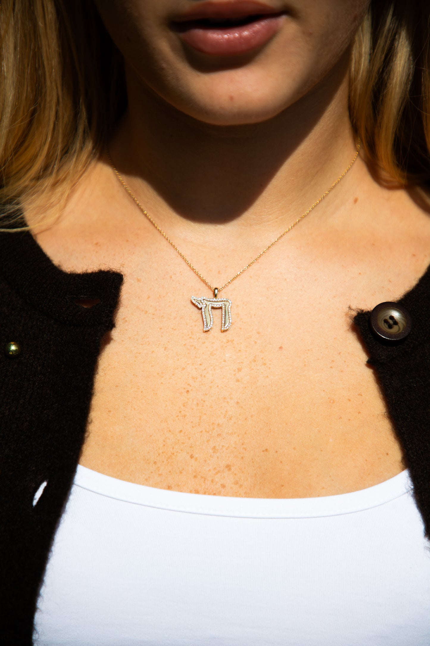 gold necklace with a Chai symbol pendant