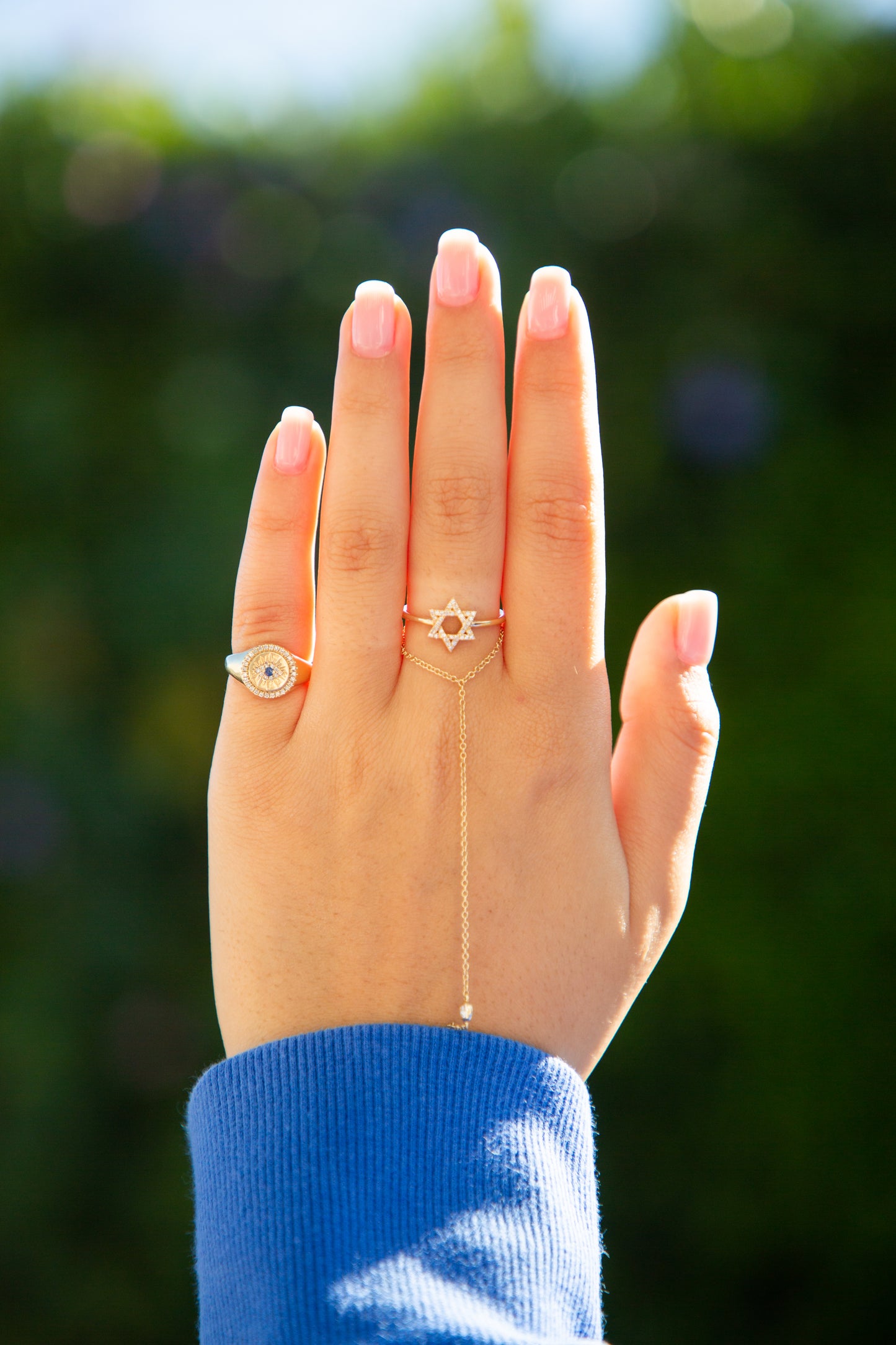 hand displaying a gold ring with a blue stone