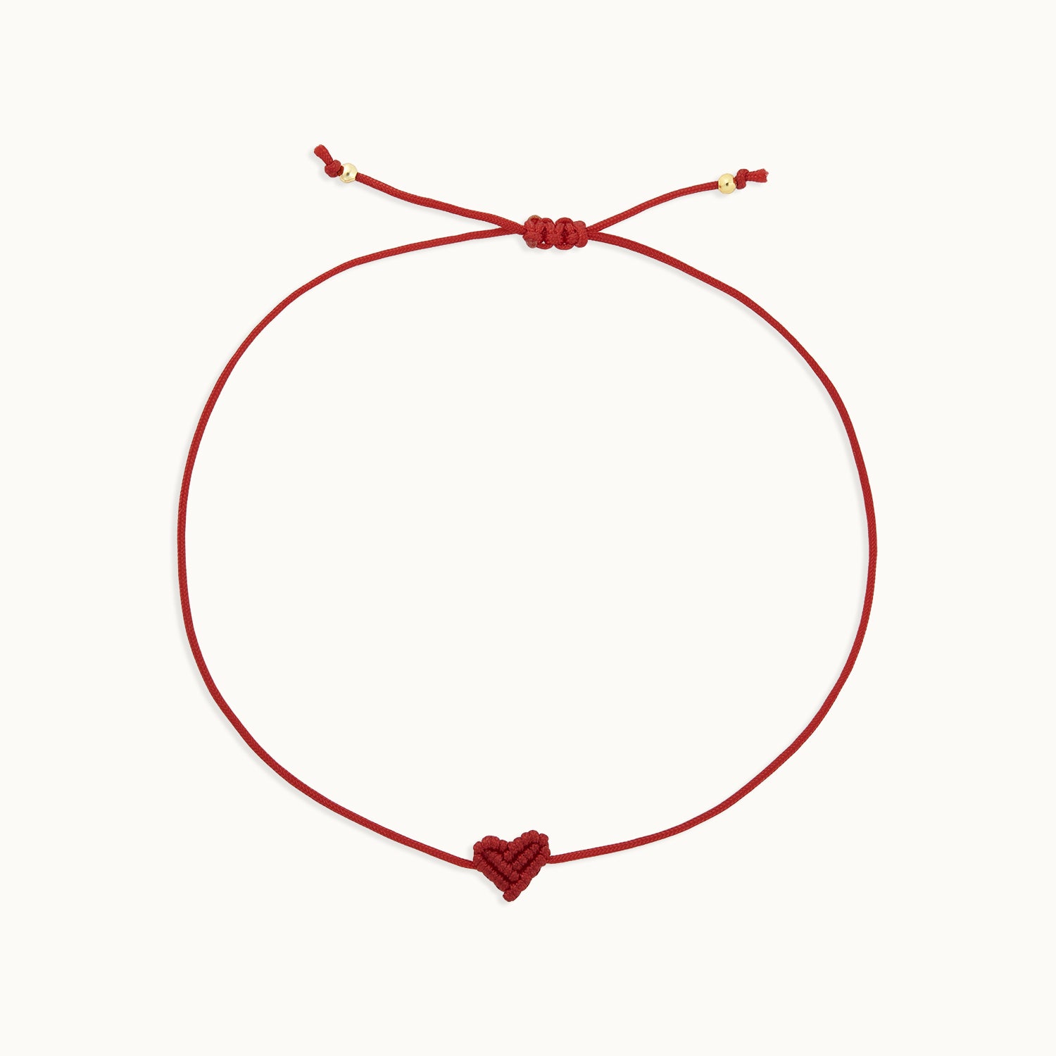 Red bracelet with a heart charm