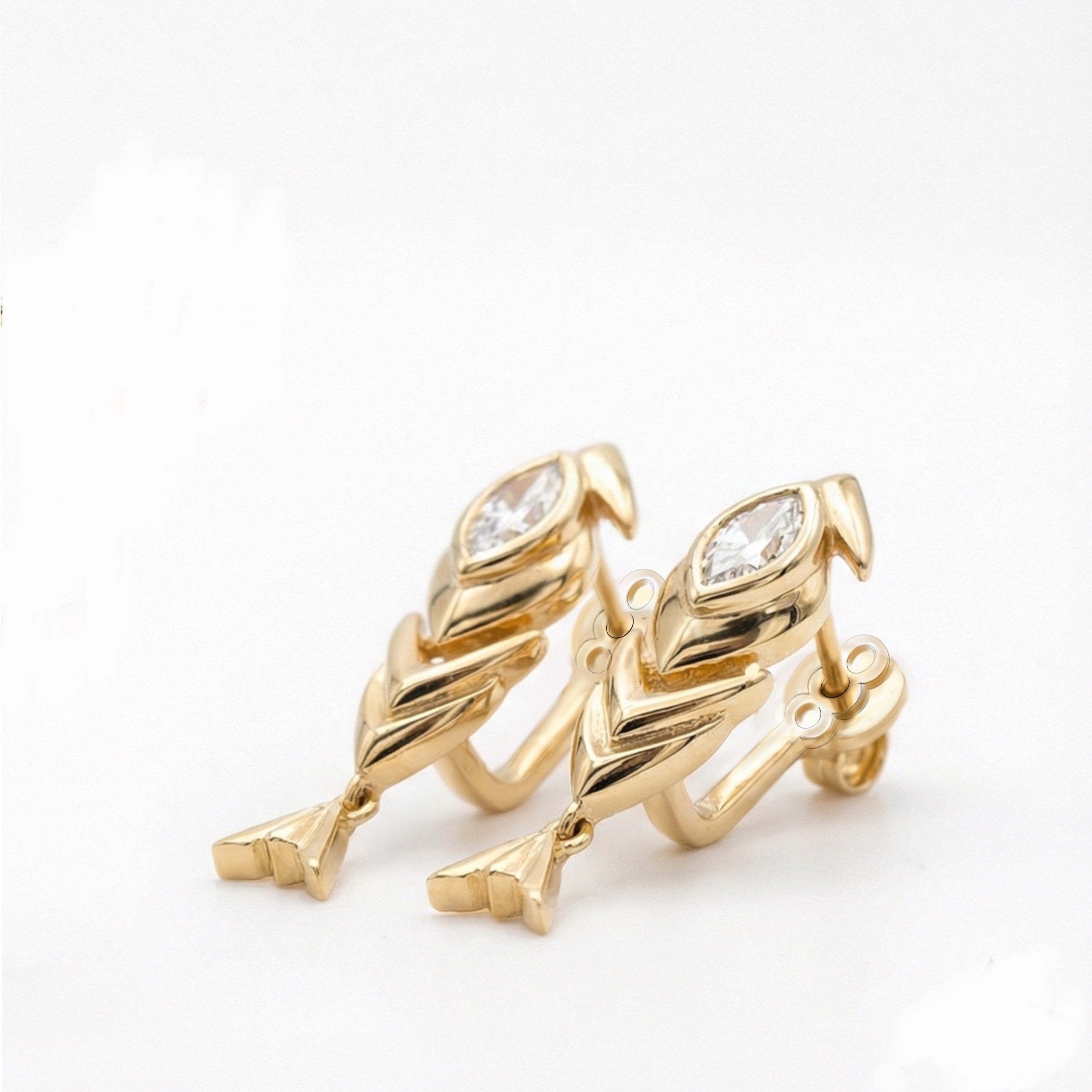 Gold earrings with leaf design and clear gemstones