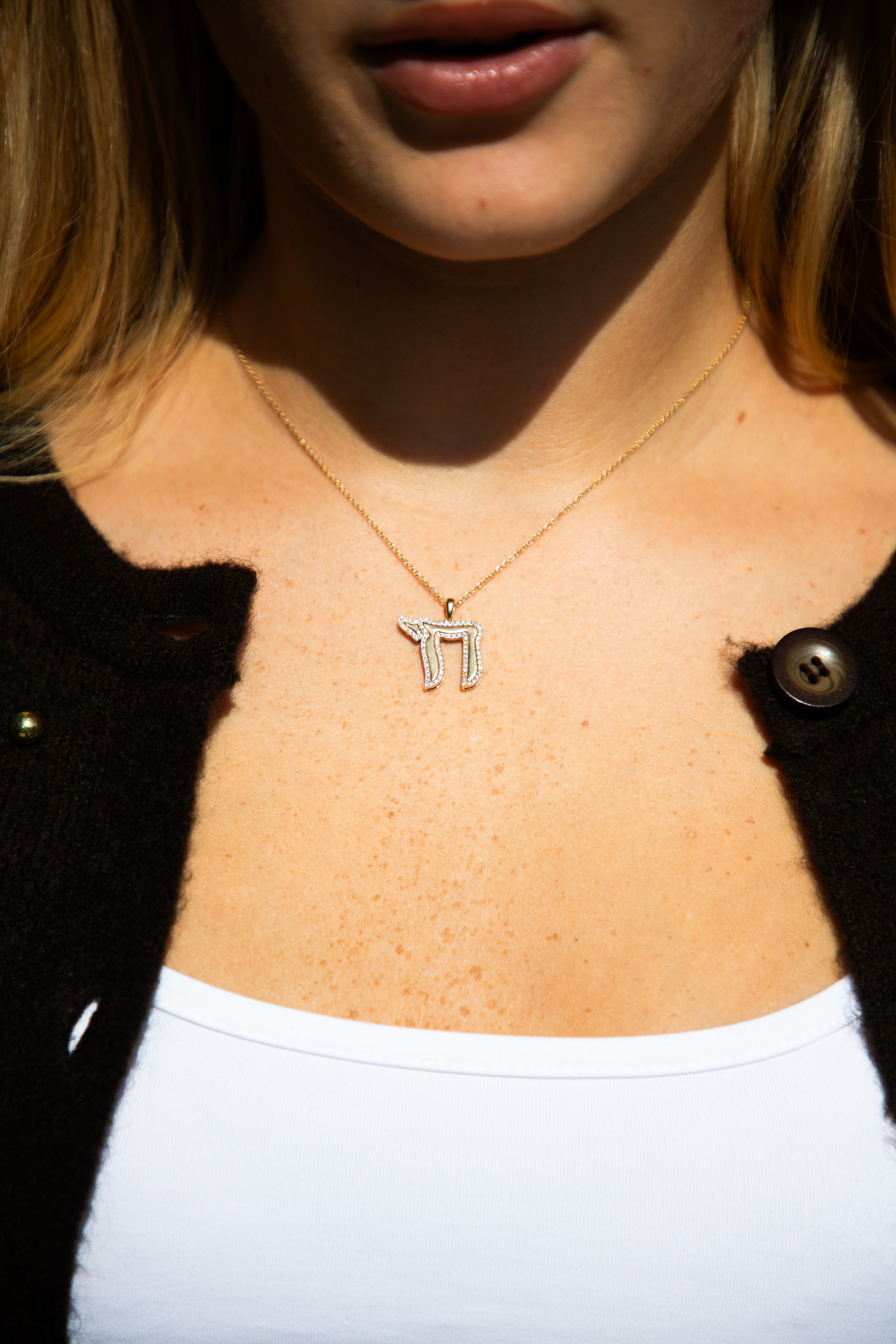 gold necklace with a Chai symbol pendant