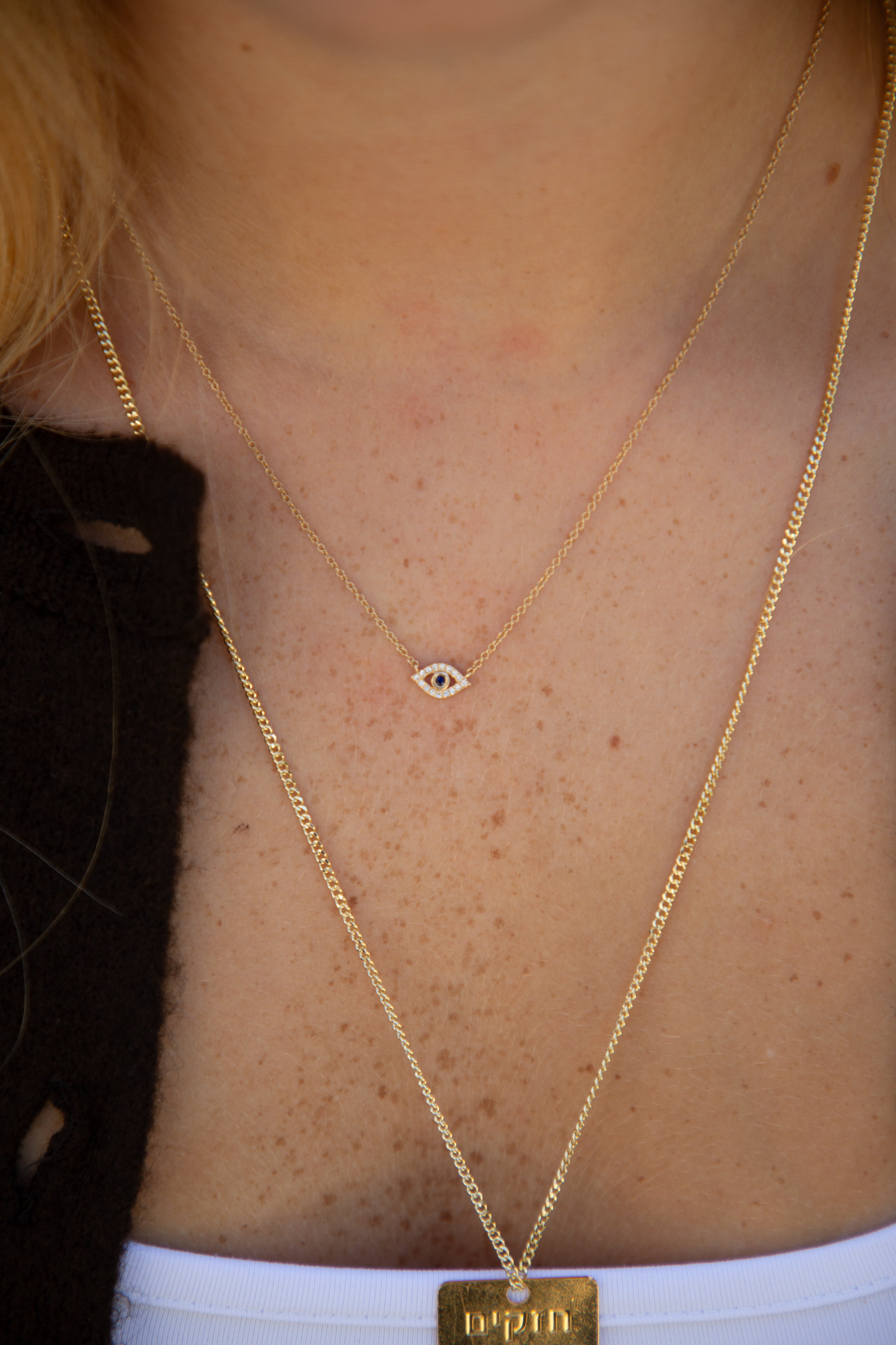 woman wearing a gold-colored necklace