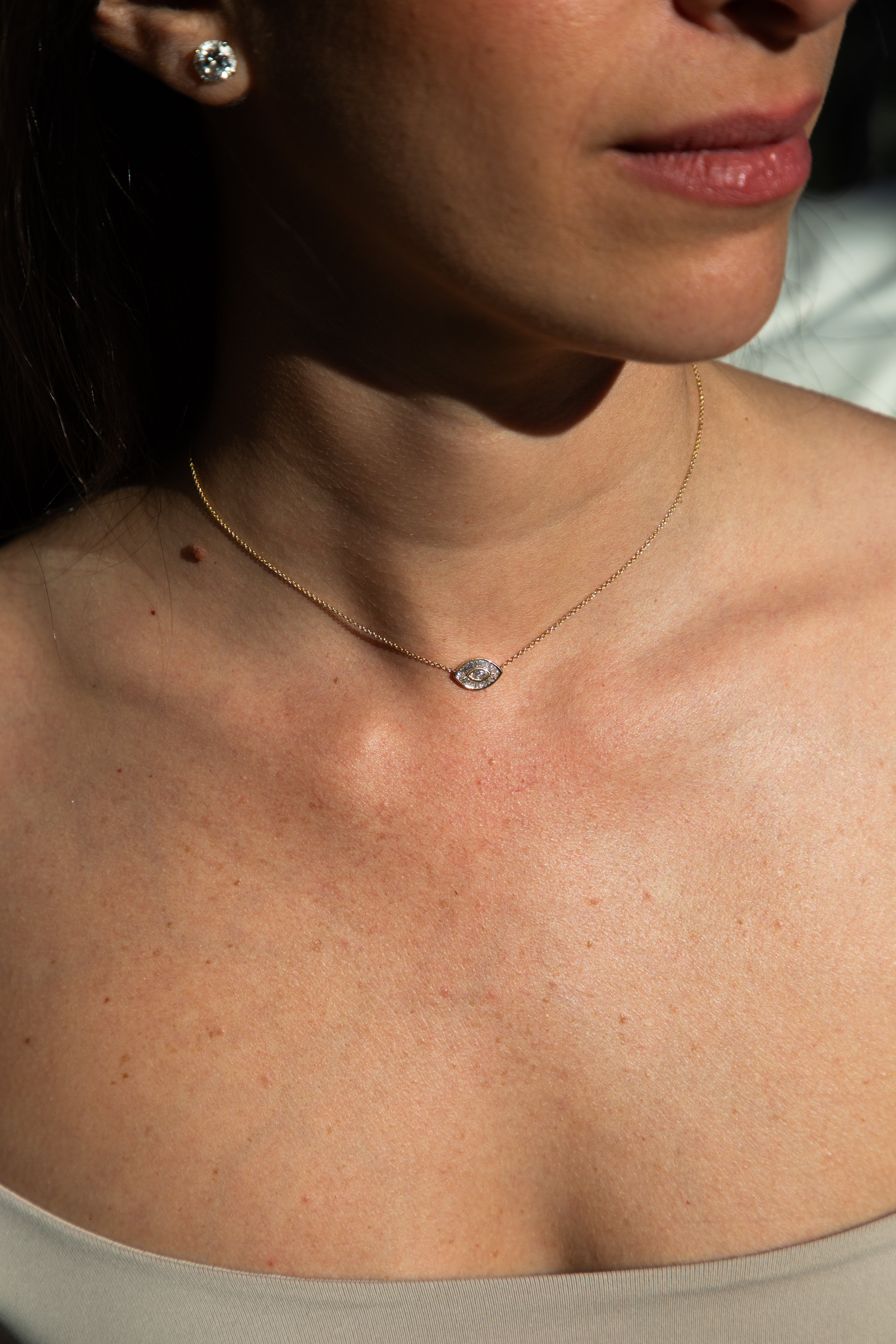 person wearing a gold necklace 