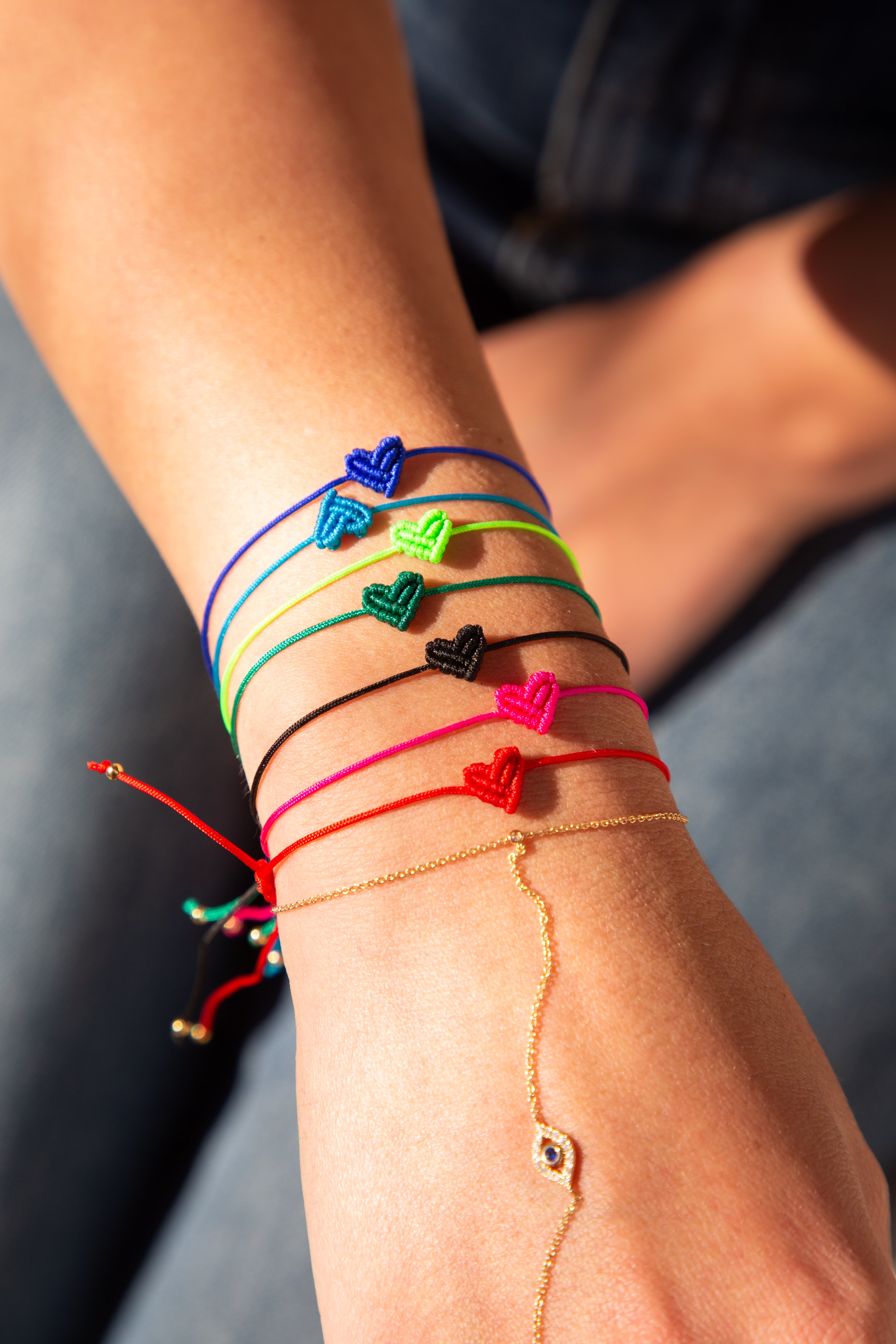 multicolored bracelets with heart-shaped charms