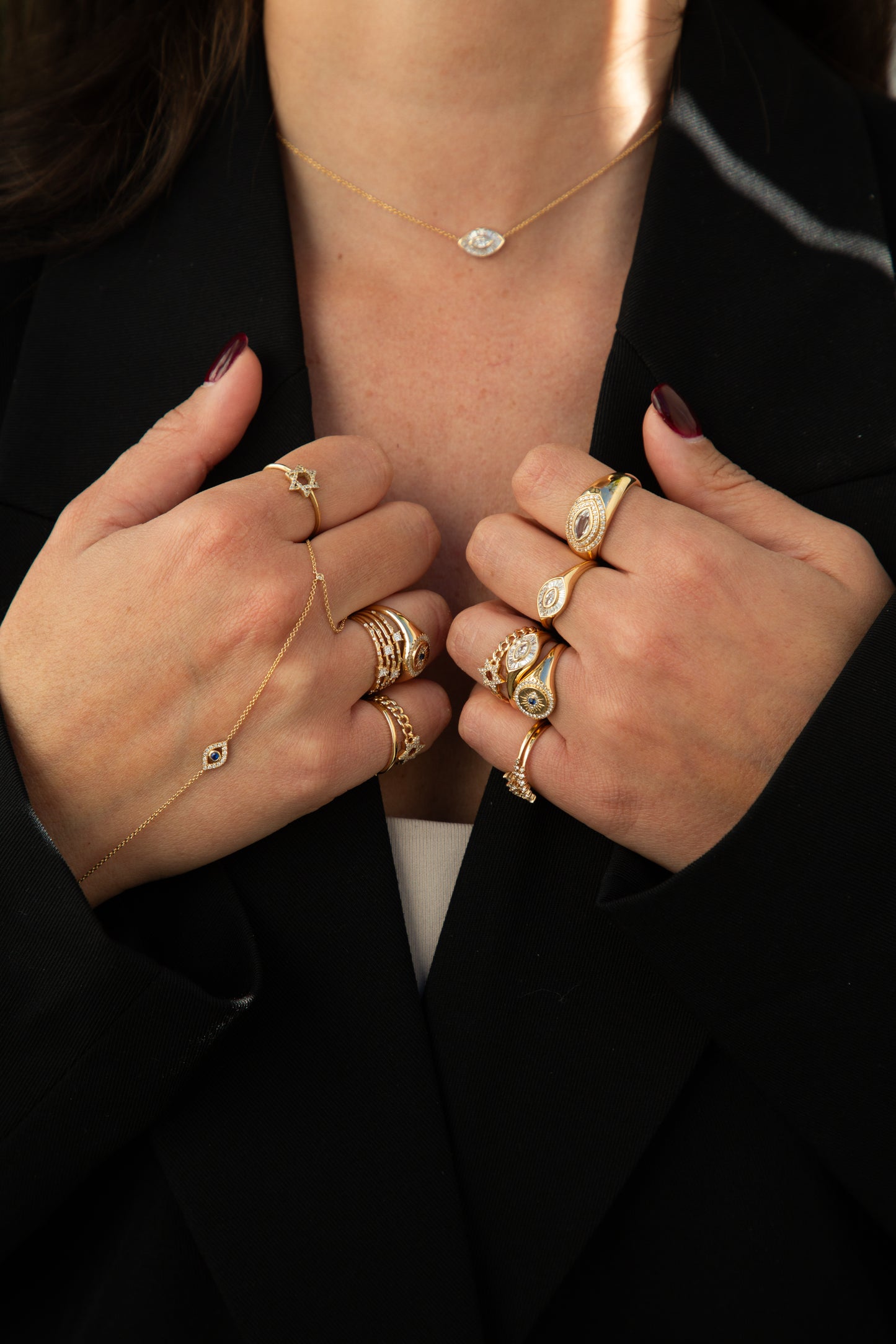 Close-up of hands wearing multiple gold rings 