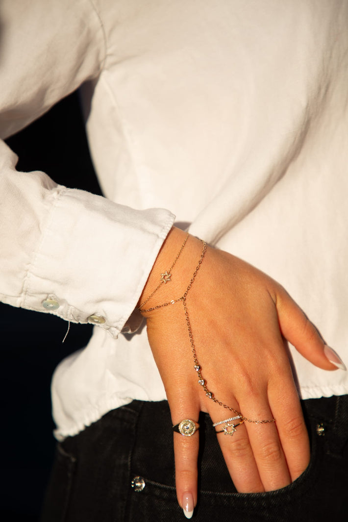 A close-up of a yellow gold Magen David bracelet