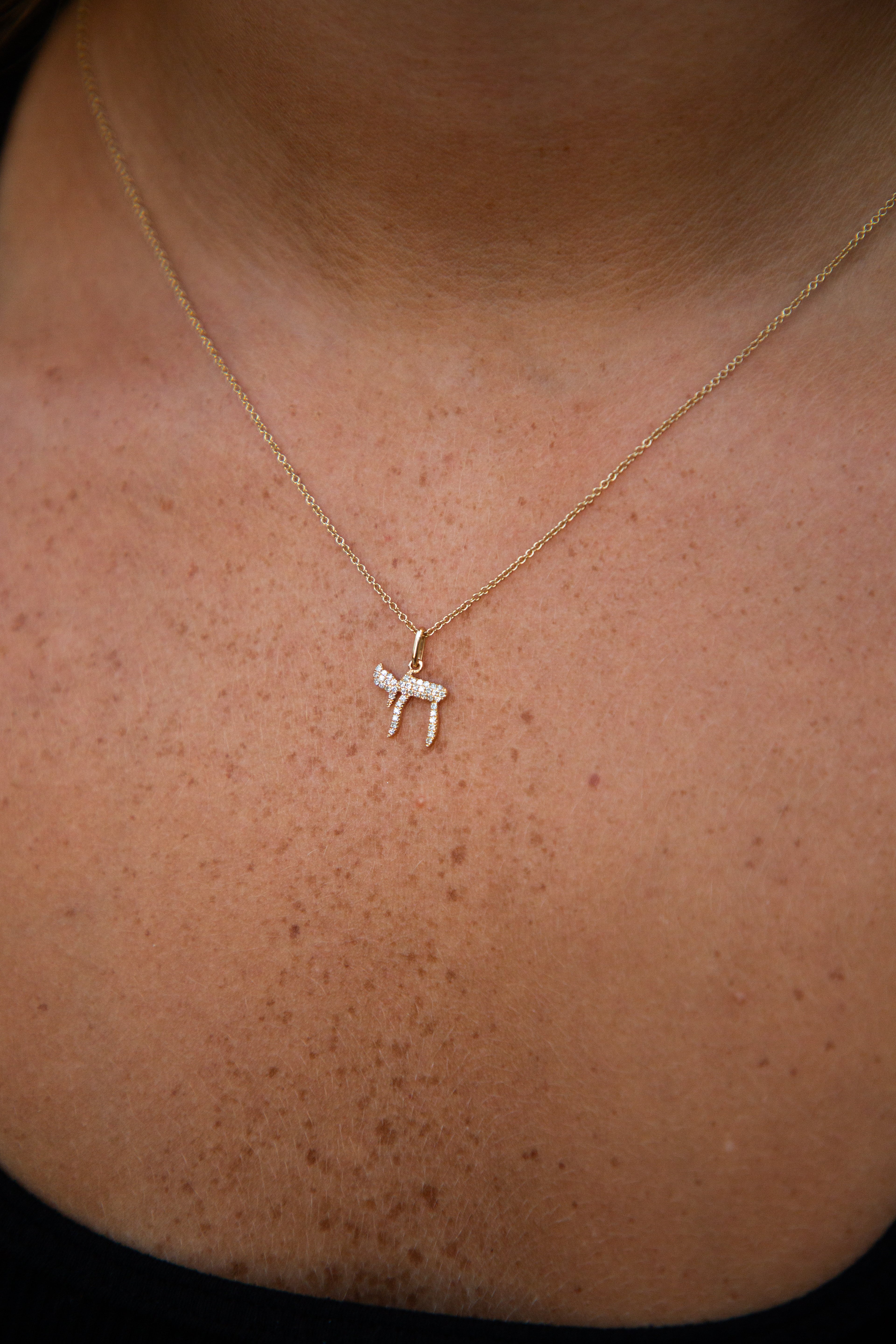 Gold necklace with a small pendant 