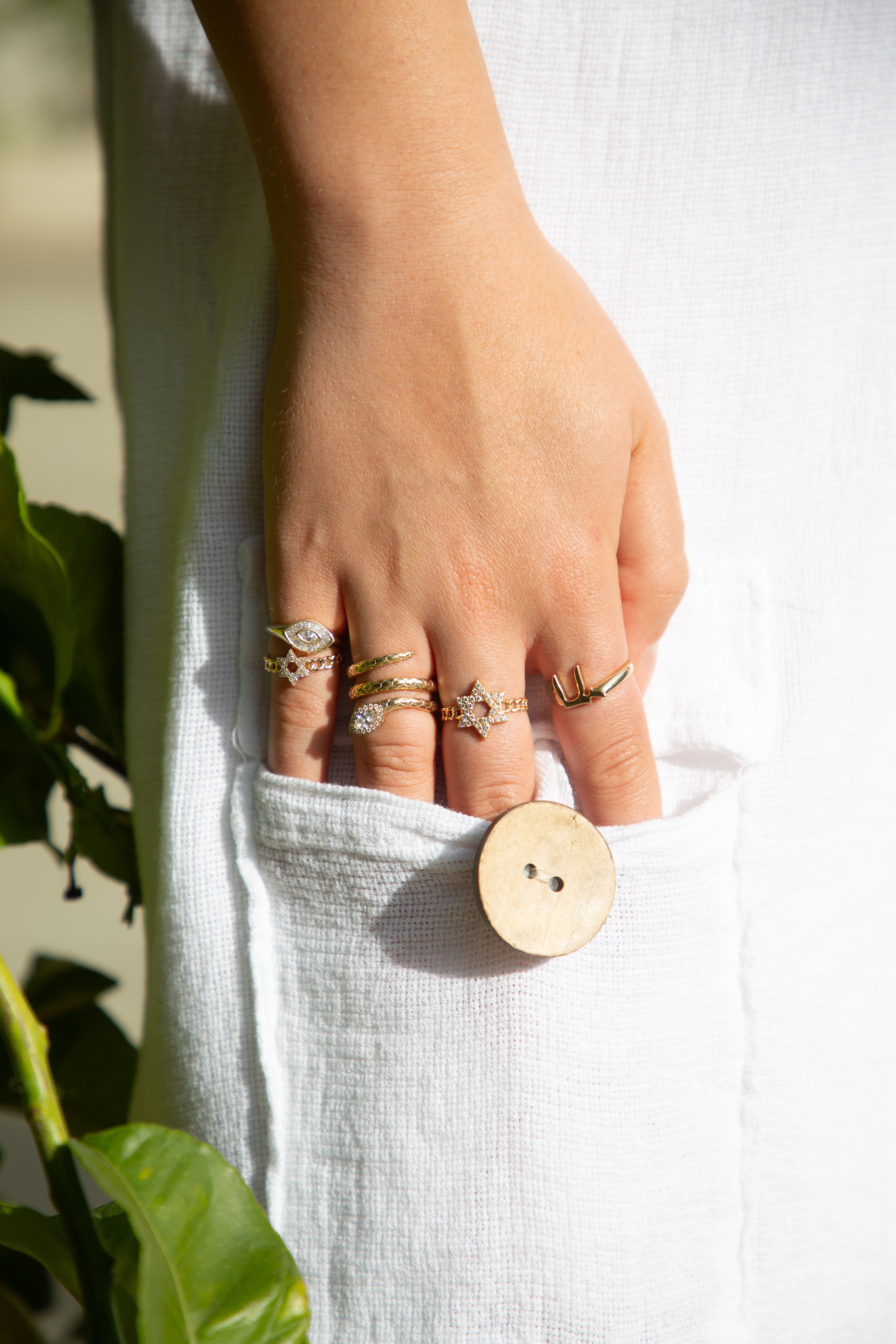 Hand wearing multiple rings 